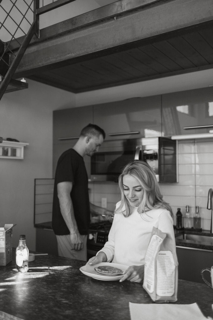 Bride and groom in the kitchen, getting ready to eat pancakes together on their elopement day