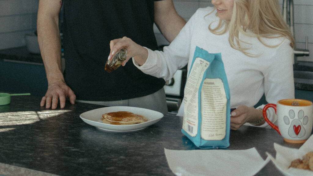 Bride pouring syrup over her pancakes 