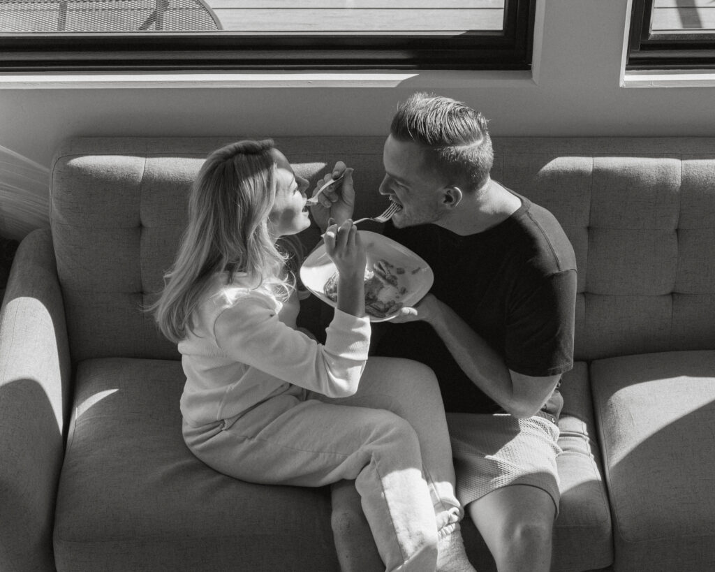 Bride and groom feeding each other pancakes 