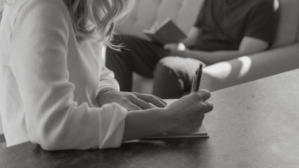 Bride writing in her vow book