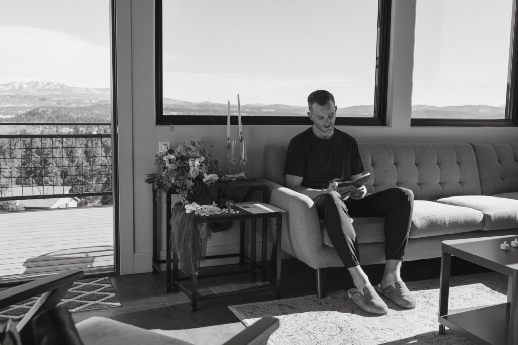 Groom privately reading his vows in their Airbnb in Pagosa Springs, Colorado