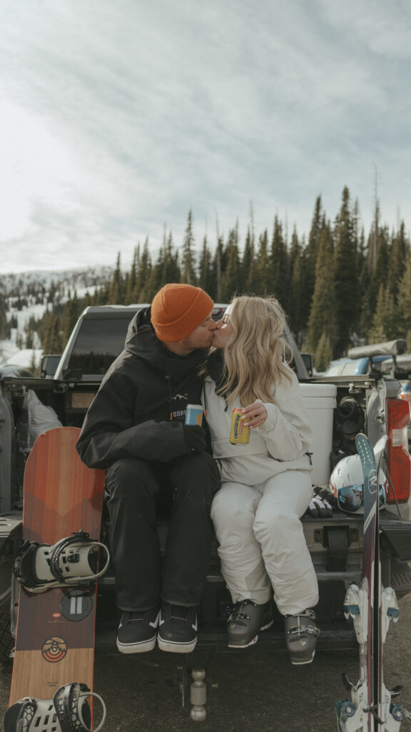 Bride and Groom sitting on tailgate at the base of the ski area in Pagosa Springs Colorado sharing a sweet kiss