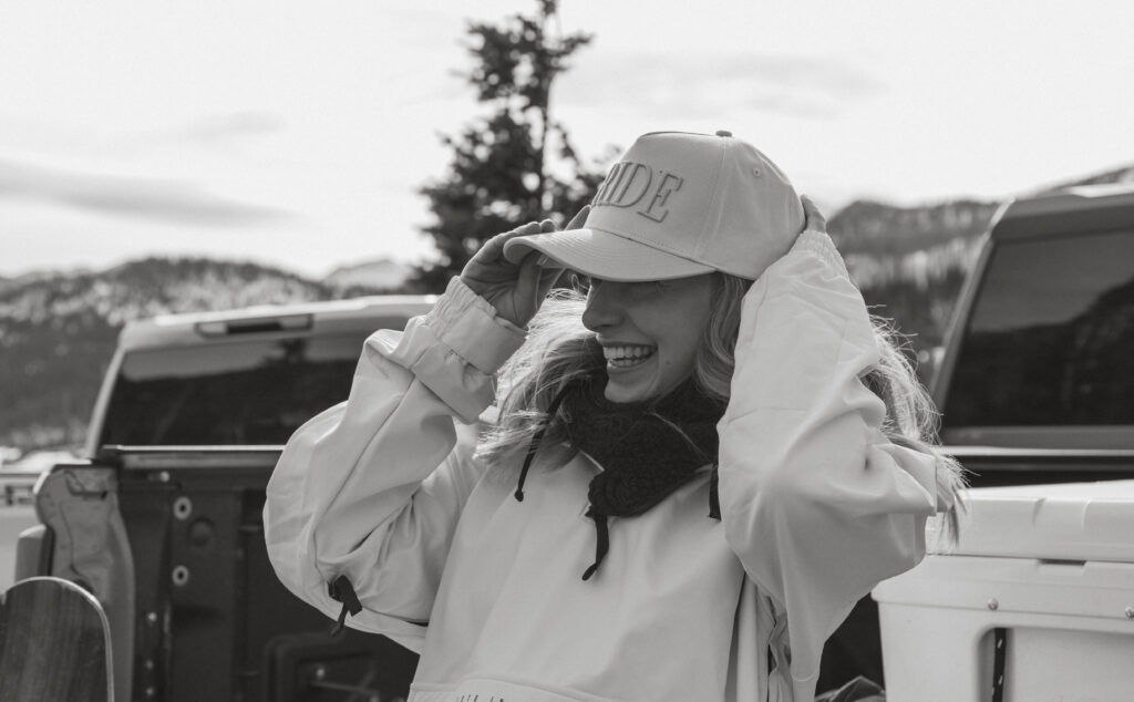 Bride laughing in cute hat on elopement day