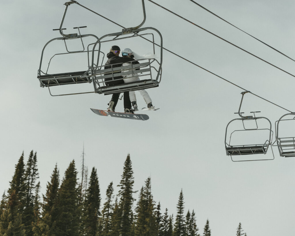 Elopement Ski Day at Wolf Creek, Bride and Groom riding the chair lift up the mountain
