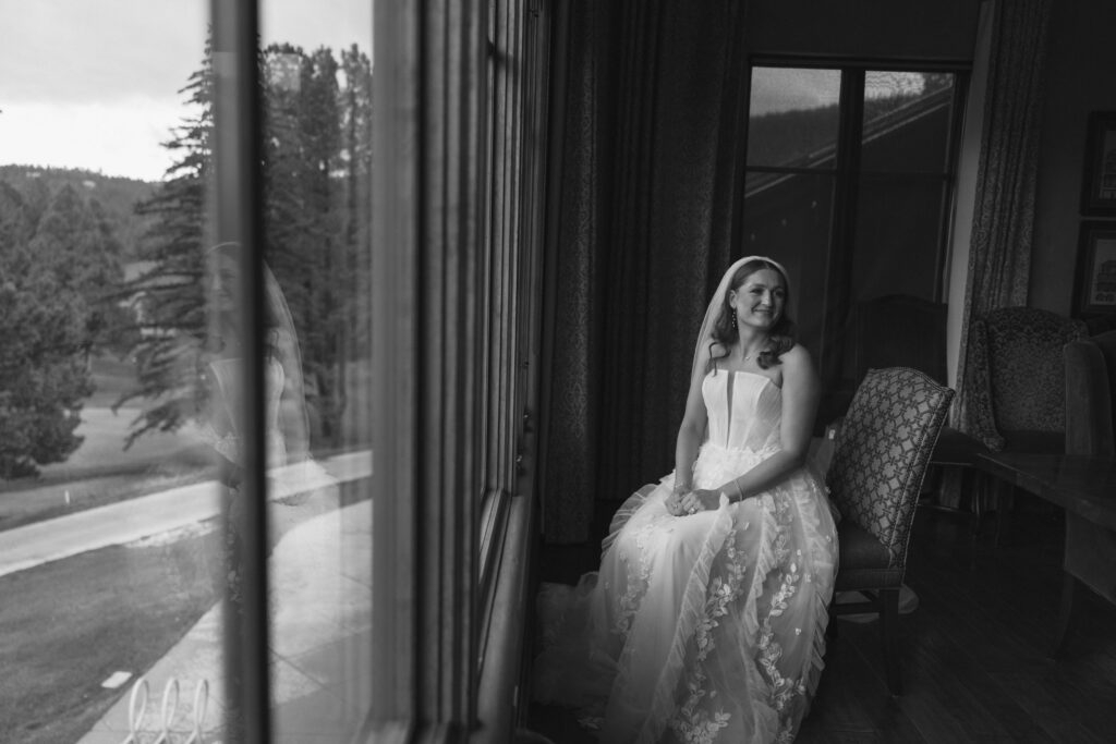 bride sitting by the window in angel fire new mexico
