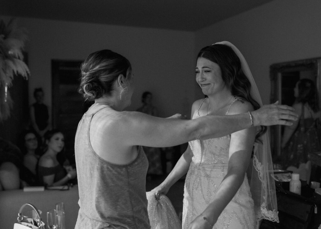 emotional bride hug with loved one before ceremony destination wedding Mexico candid moment