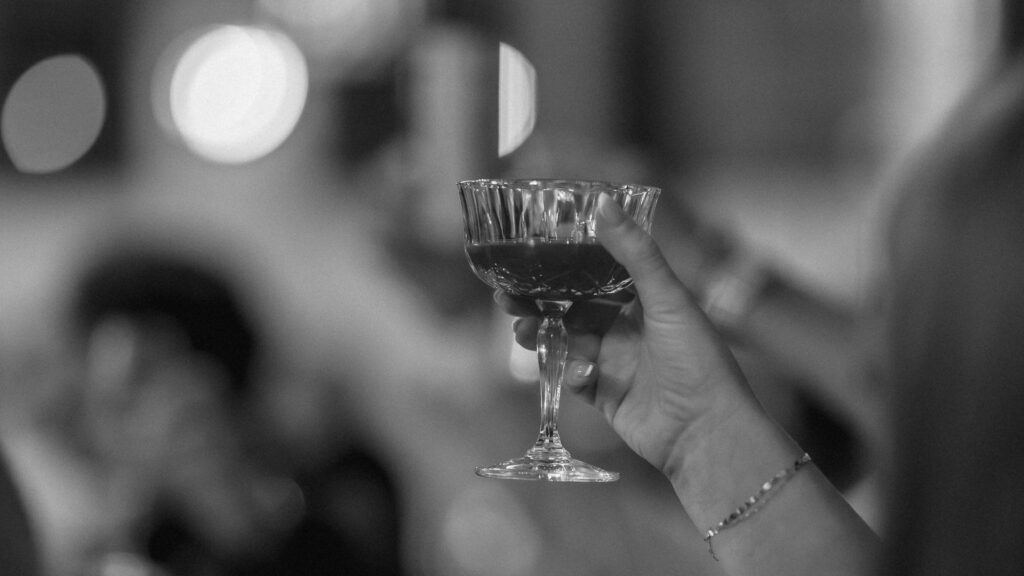 guests raising their drinks in celebration during the toasts at the reception