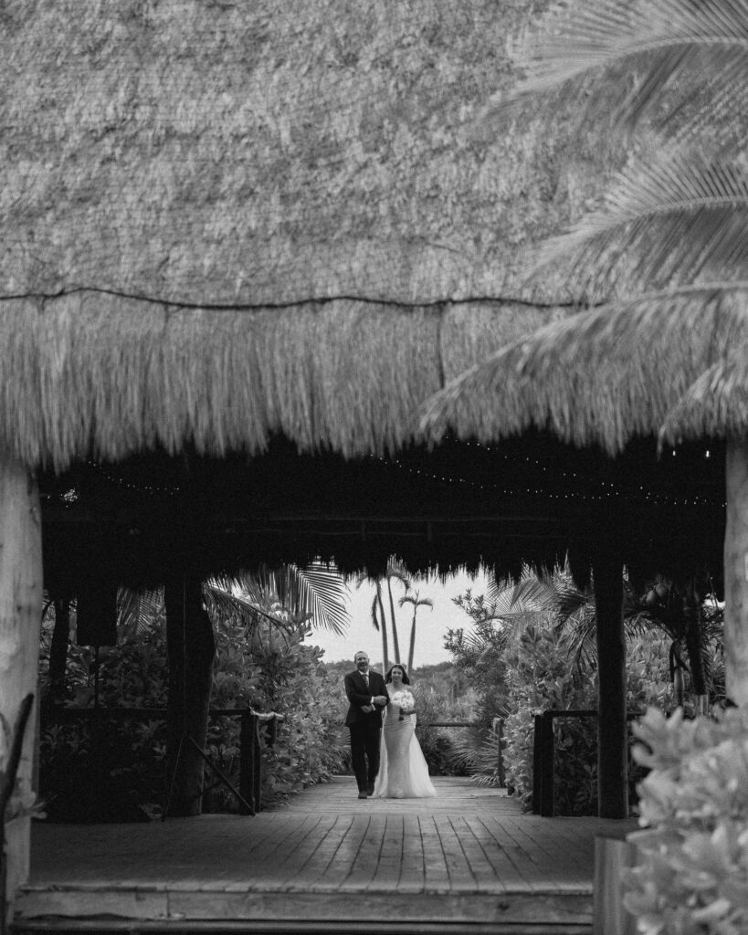 bride walking down aisle with father tropical destination wedding Mexico emotional entrance