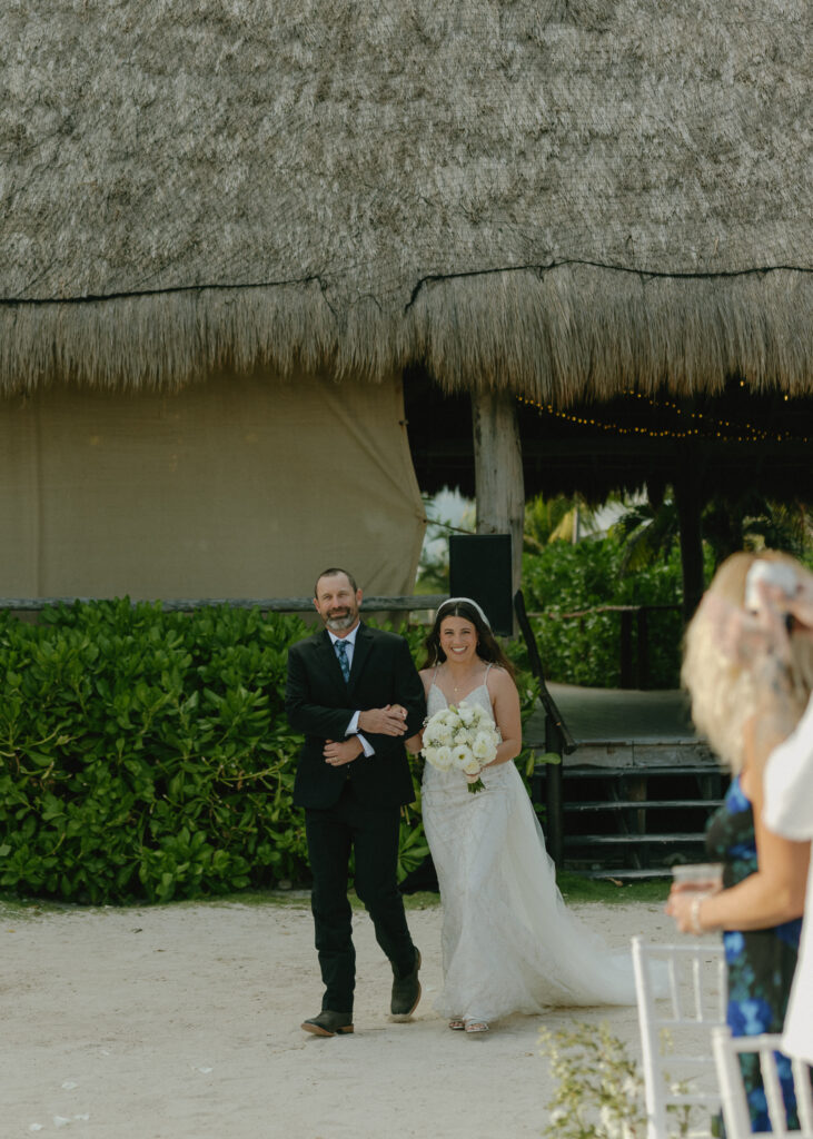 bride walking down aisle beach wedding Mexico tropical ceremony smiling joyful moment