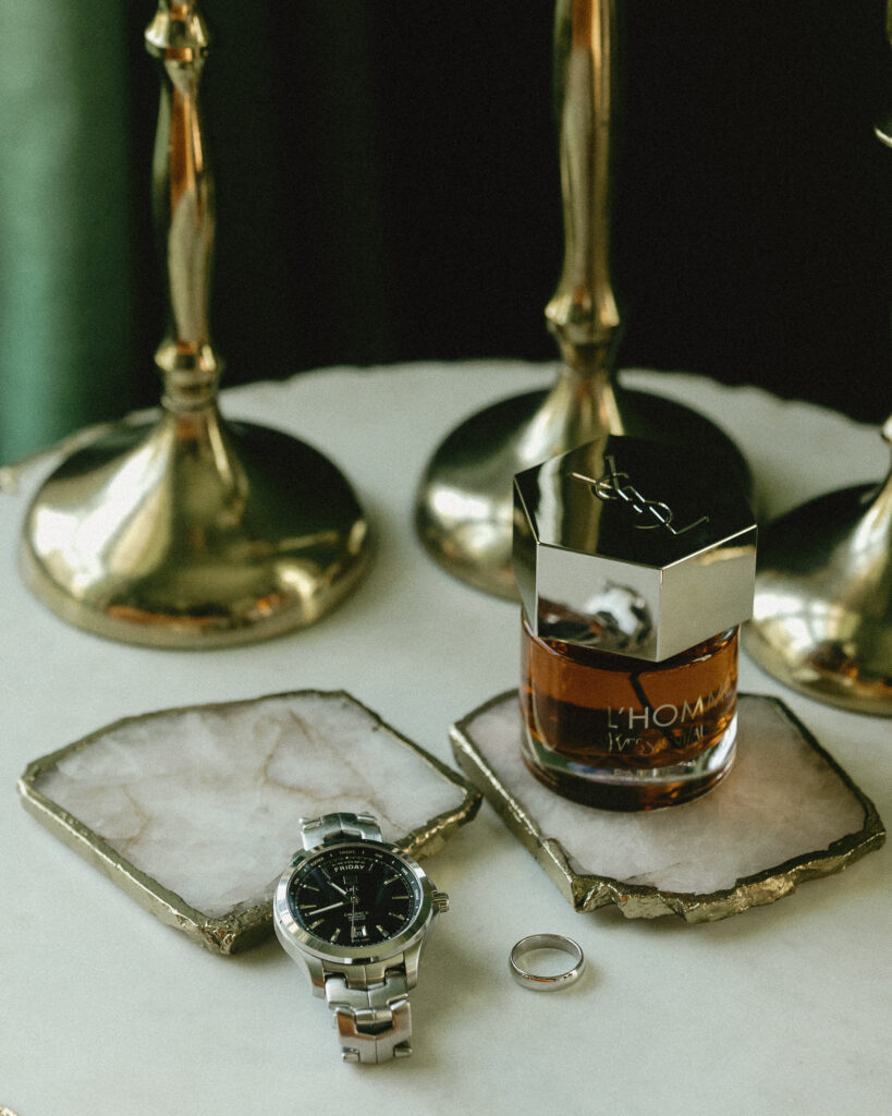 Groom detail flat lay with watch, wedding band, and cologne for Franklin Tennessee wedding