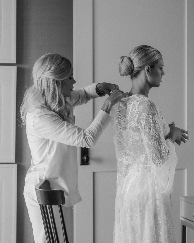 Mother helping bride into lace wedding dress during Franklin Tennessee wedding morning