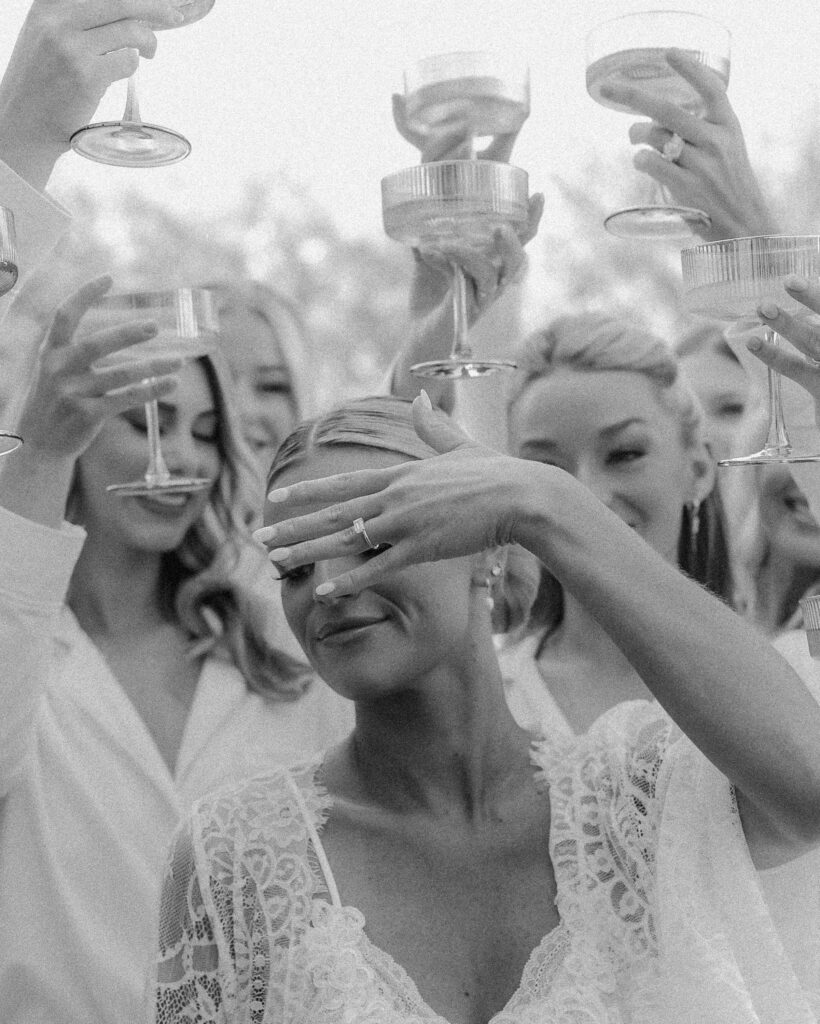 Bride celebrating with champagne and bridesmaids during getting ready moments in Franklin Tennessee wedding