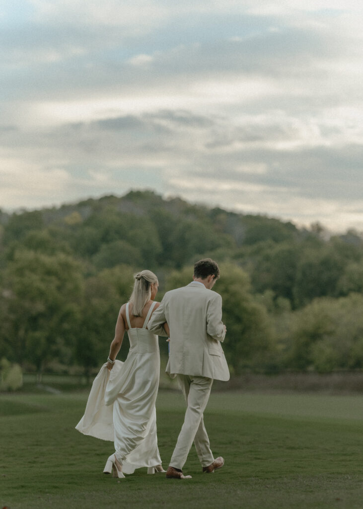 bride and groom walking out on the golf course at Westhaven Golf Club in Franklin Tennessee