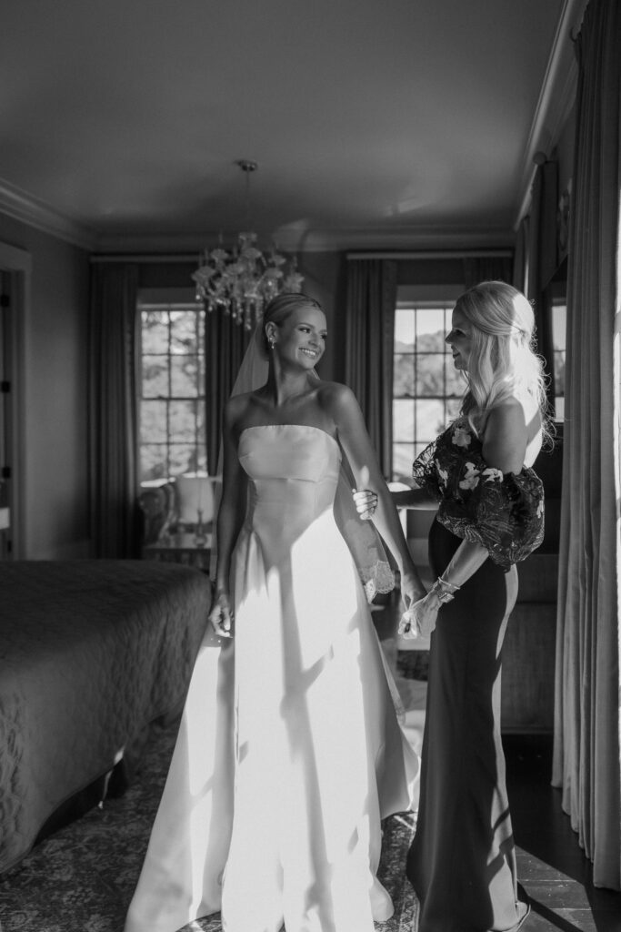 Bride standing with mom in bridal suite during getting ready moments in Franklin Tennessee wedding