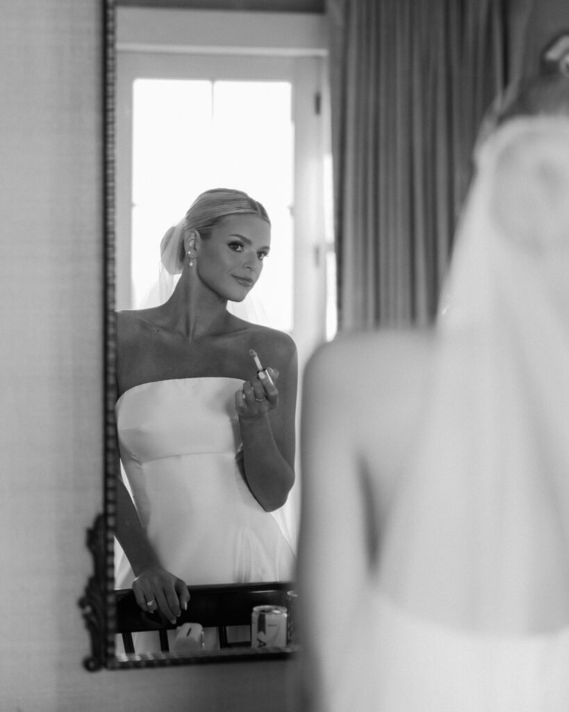 Bride looking in mirror while getting ready for elegant Franklin Tennessee wedding