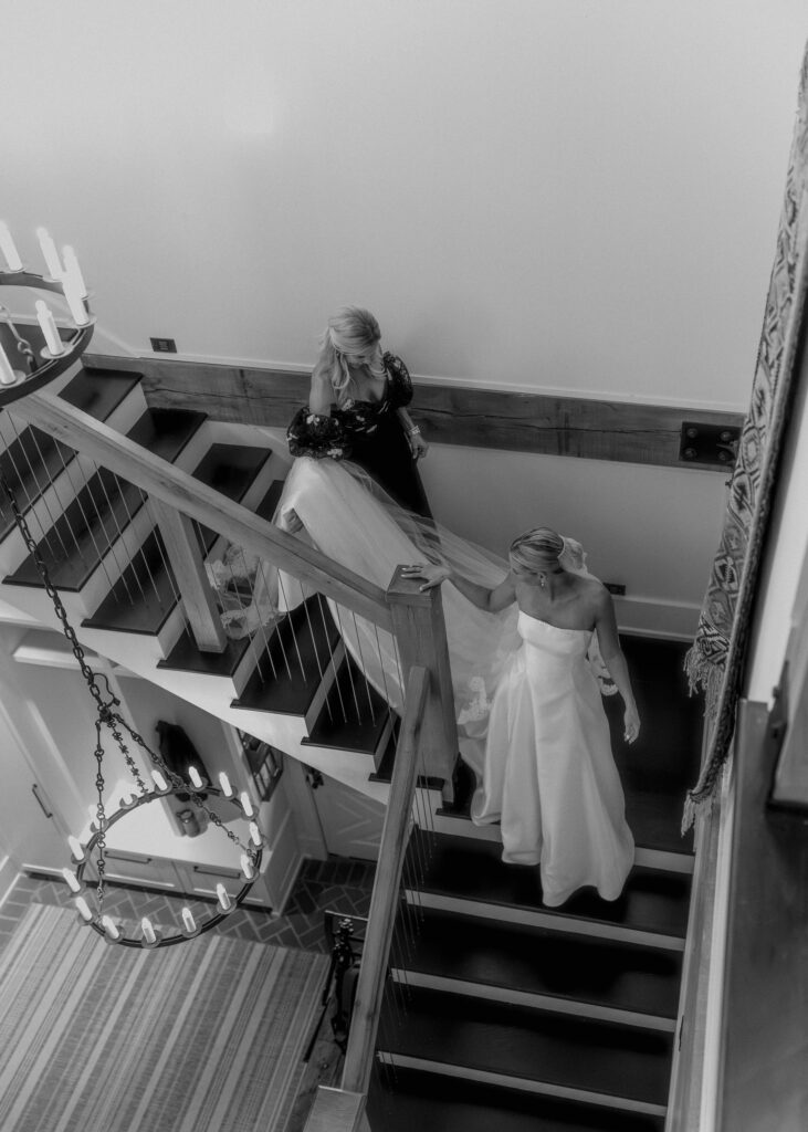 Bride walking down staircase with mom during wedding morning at Franklin TN venue