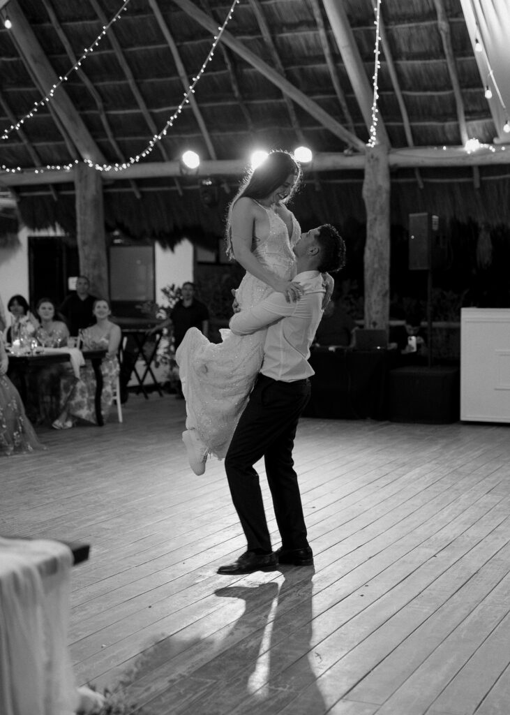 bride and groom first dance lift black and white emotional reception moment destination wedding