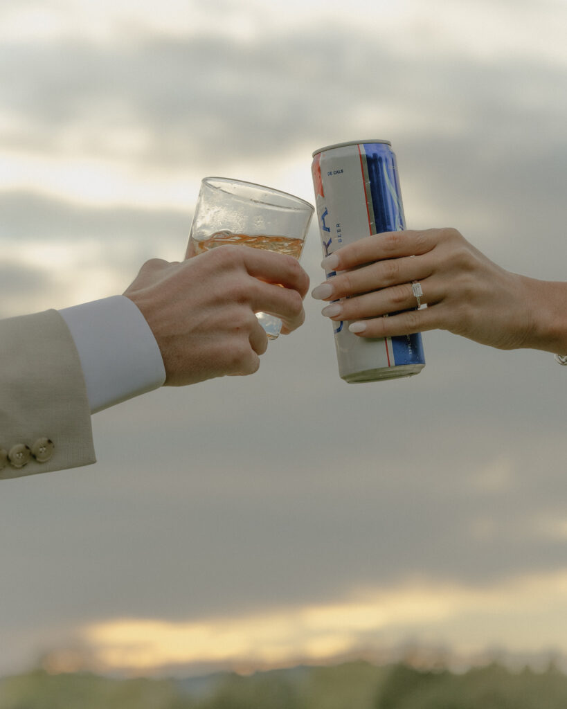 Bride and groom holding their drinks together, featuring an ultra and an old fashion