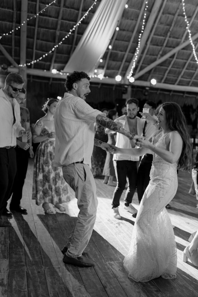 wedding guests dancing black and white reception dance floor high energy celebration