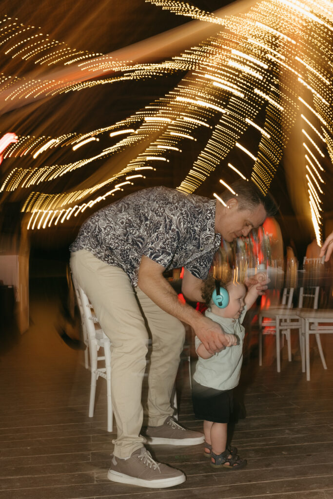 father dancing with child wedding reception candid joyful family moment destination wedding