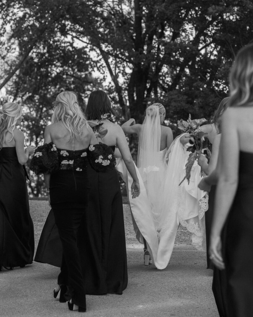 Bride walking with bridesmaids from behind during wedding day at Franklin Tennessee venue