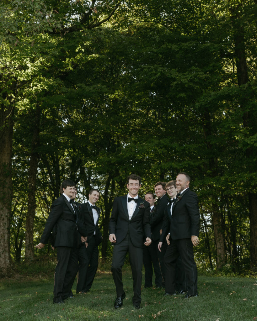 Groom and groomsmen candid moment laughing during Trinity View Farm wedding in Franklin TN