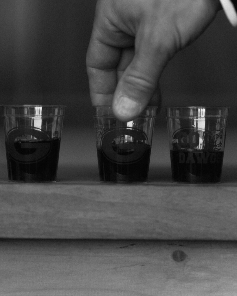 Groomsmen pouring shots during wedding celebration at Trinity View Farm in Franklin TN
