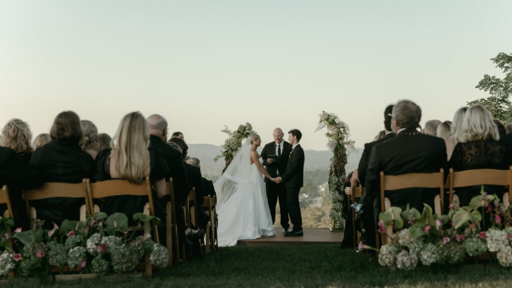 Wide ceremony view of bride and groom at altar overlooking Franklin Tennessee landscape