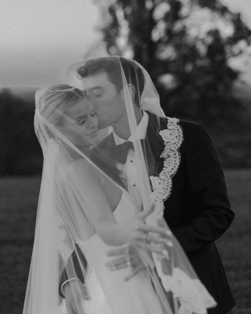 Bride and groom kissing under veil during romantic Franklin Tennessee wedding portraits