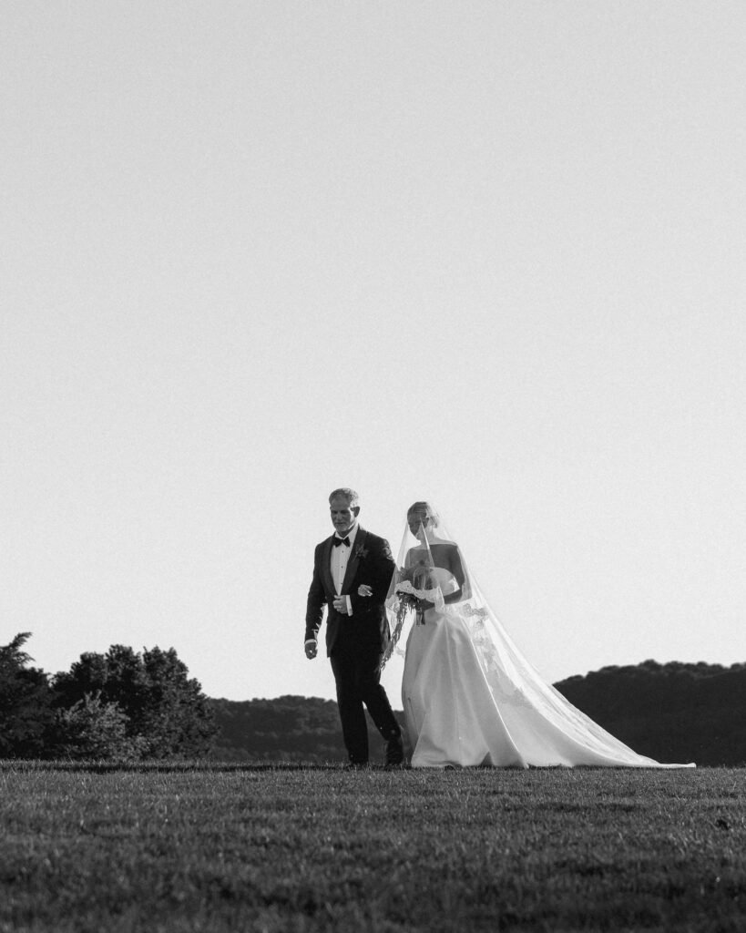 Bride walking down aisle with father overlooking Tennessee hills at Franklin wedding