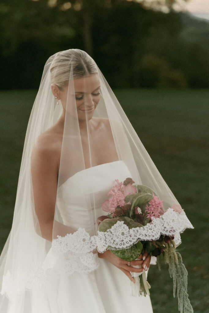 Bride holding bouquet with veil during golden hour wedding portraits in Franklin TN