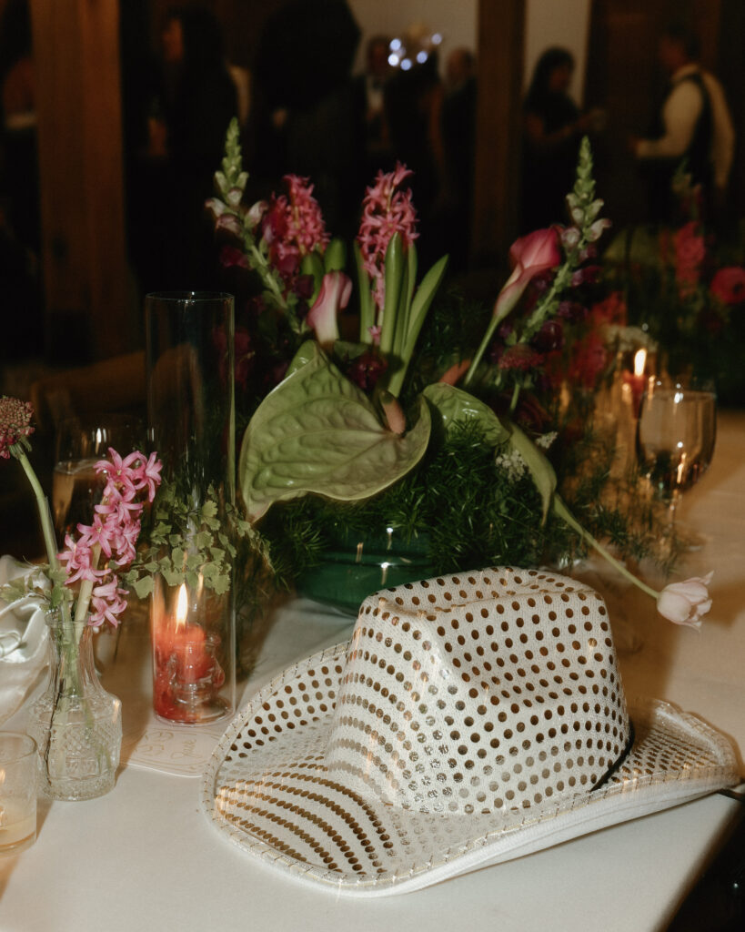 Wedding reception table decor with florals and cowboy hat at Franklin Tennessee wedding