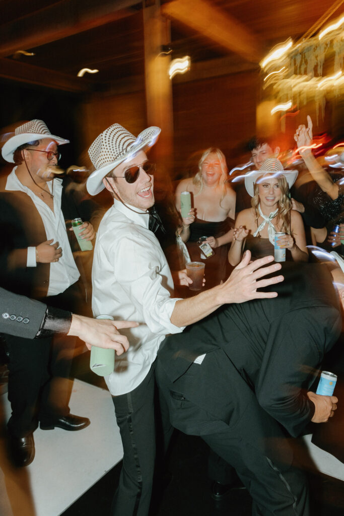 Guests dancing and celebrating on crowded dance floor at Trinity View Farm wedding