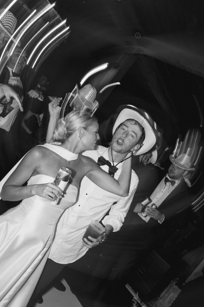 Bride and groom dancing with drinks during lively reception at Trinity View Farm
