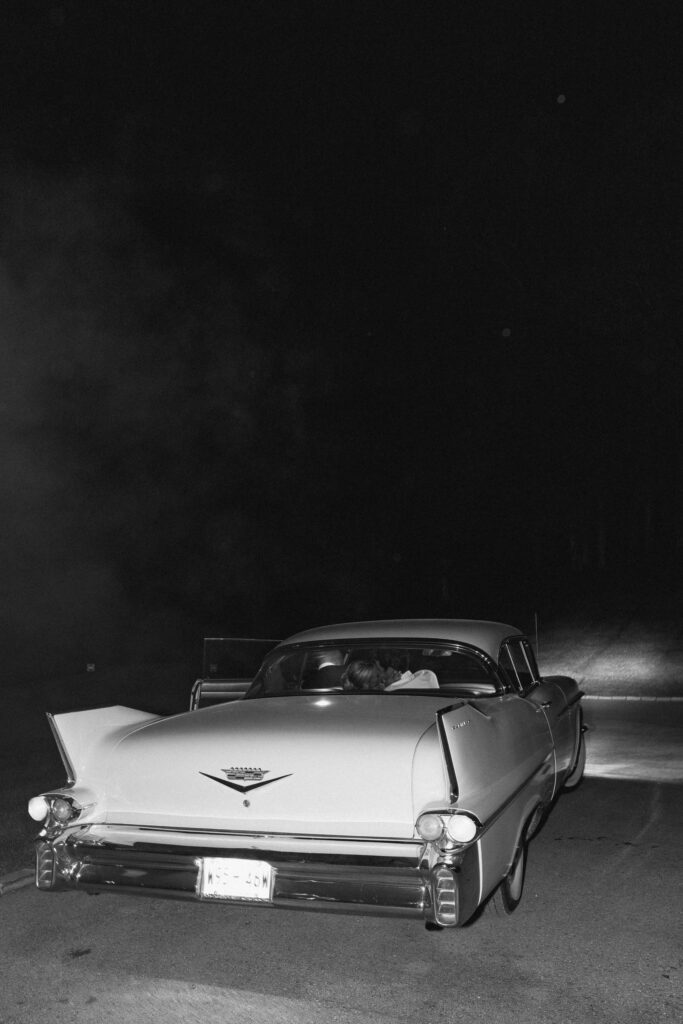 Vintage getaway car driving away after wedding exit at Trinity View Farm in Franklin TN