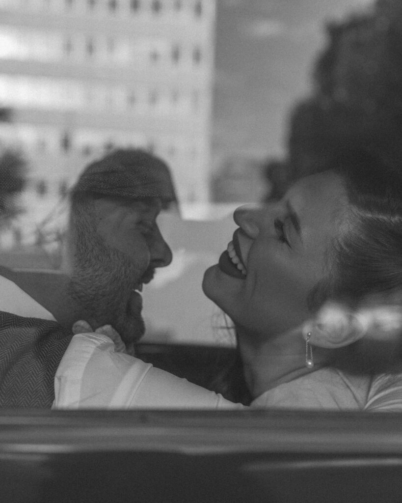 romantic candid couples moment inside vintage car Amarillo Texas black and white photo