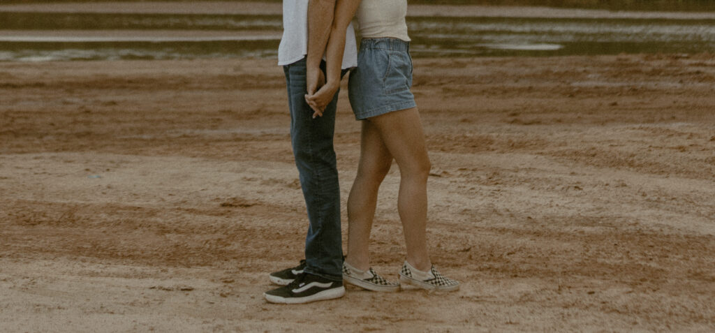 Close-up of couple holding hands in desert during Amarillo engagement session