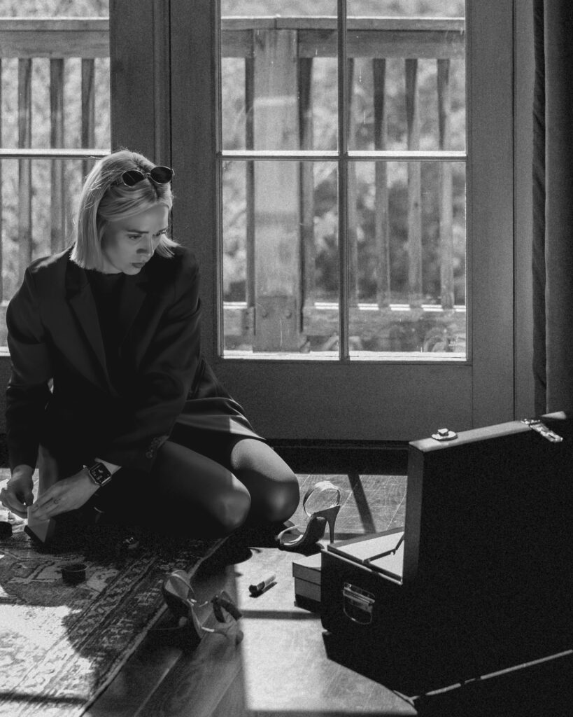 photographer by window with suitcase and details, natural light wedding morning moment, detailed flat lay photographs