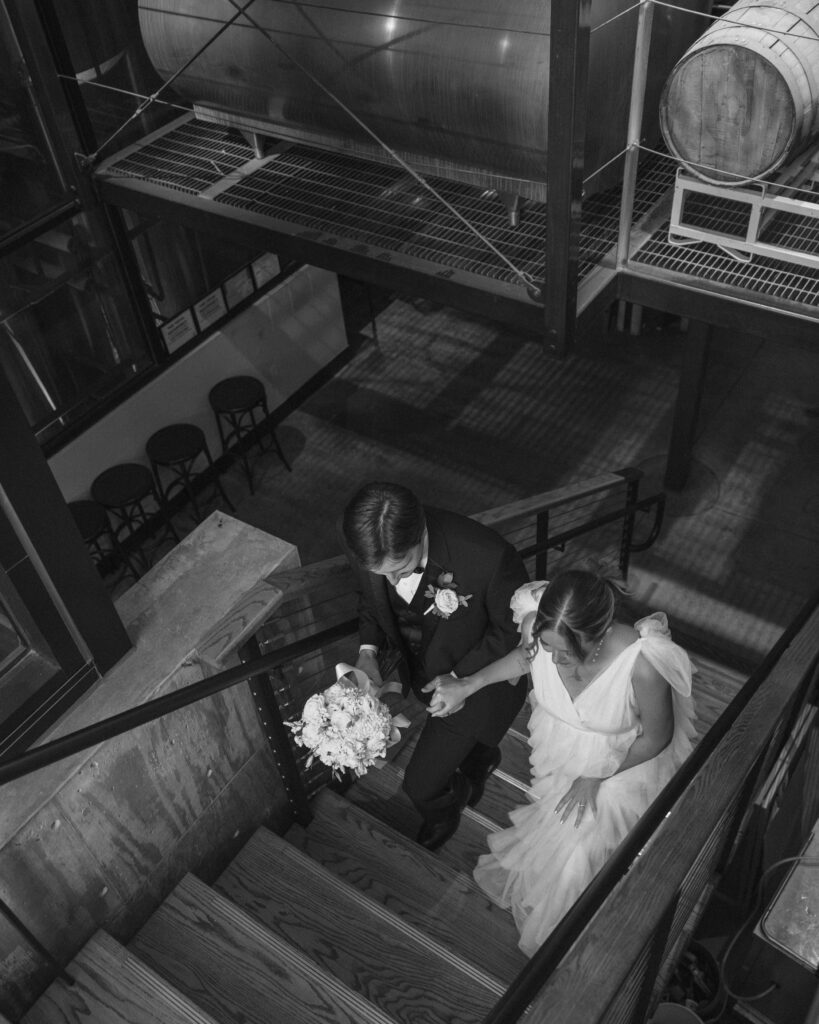 bride and groom walking up the stairs at 6 Car Brewery in Downtown Amarillo, TX