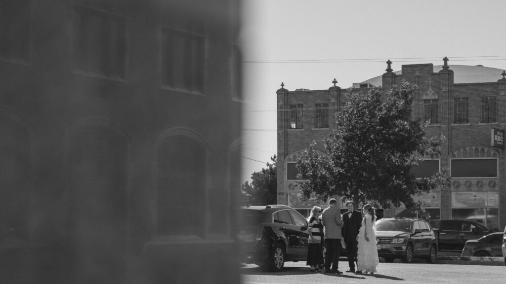 Bride and Groom standing in the parking lot outside of the Santa Fe Courthouse Building in downtown Amarillo Texas